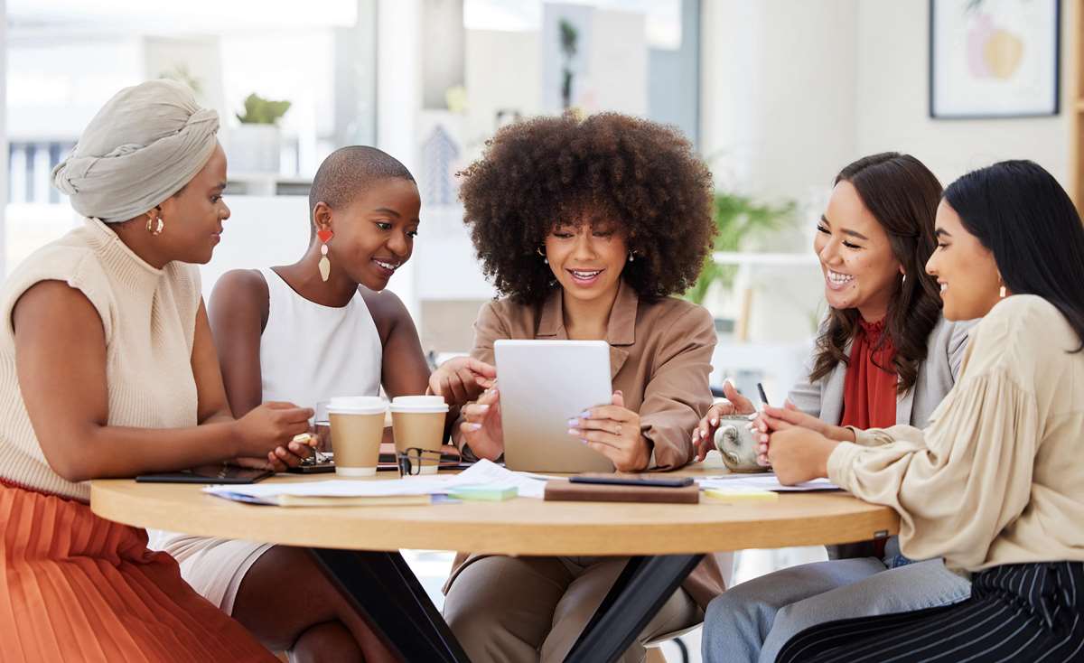 Power Collective Commercial Realty - trusted commercial real estate broker in Indiana - Our mission image diverse group of women working over coffee